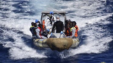 Migrants sit in a rescue boat during a rescue operation by Italian Navy vessels off the coast of Sicily in this April 11, 2016 (Reuters)