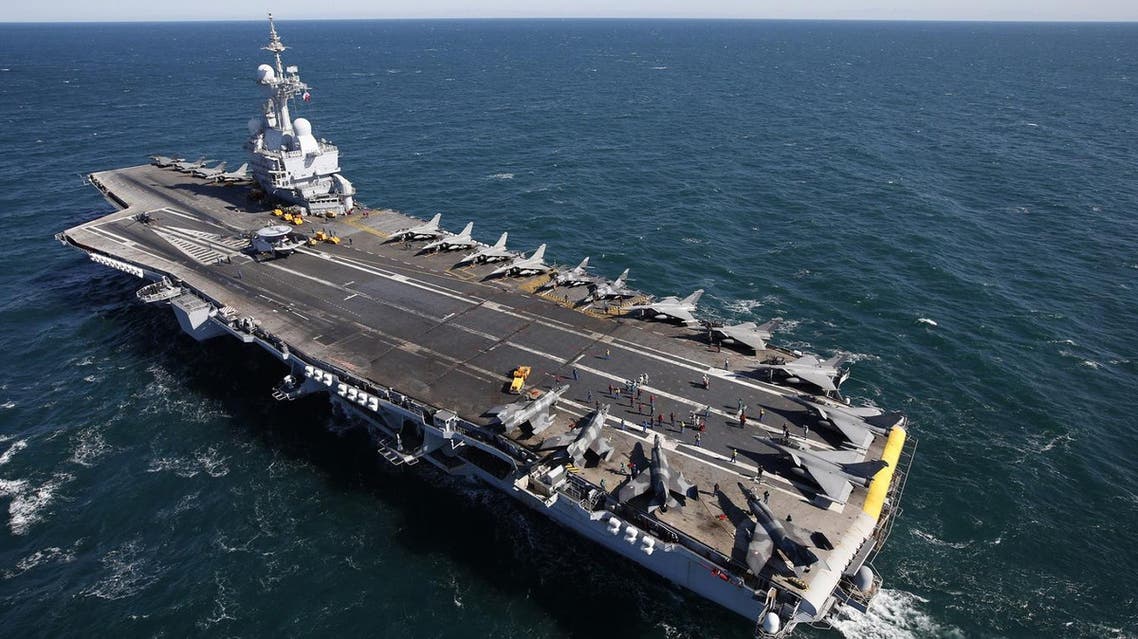 Rafale and Super Etendards fighter jets are parked prior to a mission aboard France's Charles de Gaulle aircraft carrier sailing in the Gulf, January 28, 2016. (Reuters)