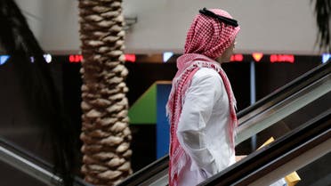 A Saudi man stands on an escalator at the Tadawul Saudi Stock Exchange, in Riyadh, Saudi Arabia, Monday, June 15, 2015. (AP)