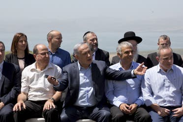 Israeli Prime Minister Benjamin Netanyahu (C front) poses with ministers prior to the weekly cabinet meeting in the Israeli occupied Golan Heights near the ceasefire line between Israel and Syria, April 17, 2016. (Reuters)