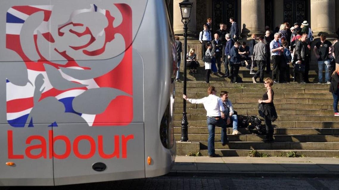 Labour Party supporters and members of the media wait on the steps of Leeds Town Hall, prior to attending a rally in Leeds. (AFP)