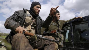 Ahrar al-Sham fighters gesture as they ride a pickup on the frontline of Idlib city in northern Syria. (Reuters)