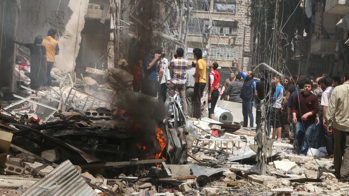 People inspect the damage at a site hit by airstrikes, in the rebel-held area of Aleppo's Bustan al-Qasr, Syria April 28, 2016. Reuters
