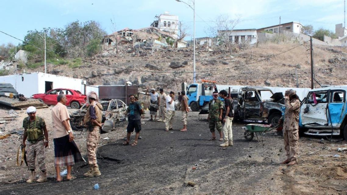 Yemeni loyalist forces and onlookers gather at the scene of a suicide attack targeting the police chief in the base of the Saudi-backed government on April 28, 2016 in Yemen's second city Aden (AFP)