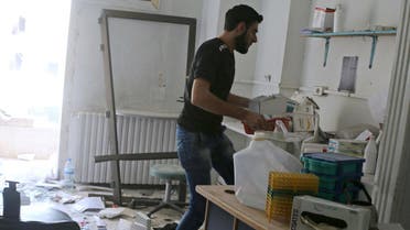 A man removes medicine inside al-Quds hospital after it was hit by airstrikes, in a rebel-held area of Syria. Reuters
