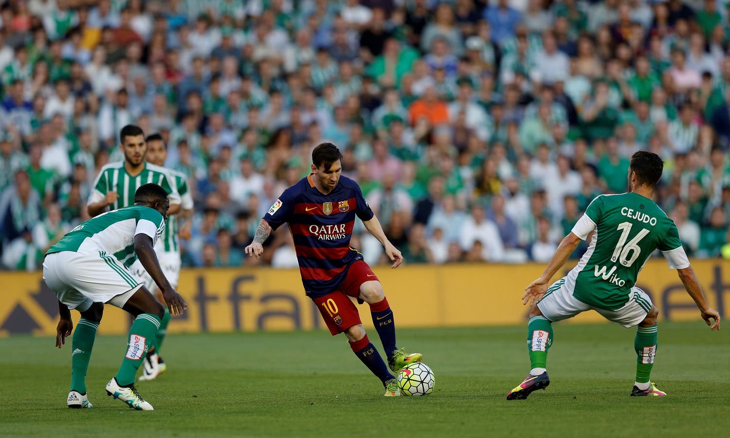 Barcelona's Leo Messi in action between Real Betis' players. REUTERS