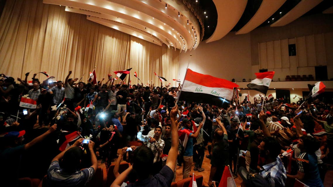 Followers of Iraq's Shi'ite cleric Moqtada al-Sadr are seen in the parliament building as they storm Baghdad's Green Zone after lawmakers failed to convene for a vote on overhauling the government, in Iraq April 30, 2016