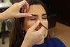 Al Arabiya's business anchor Rania Abi Nader getting her make-up done