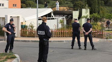Police officers stand outside a Muslim prayer room set on fire early in the morning in Ajaccio, French Mediterranean island of Corsica, Saturday, April 30, 2016. (AP)