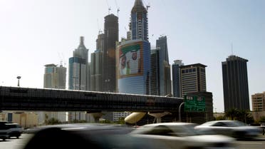 This March 9, 2011, file photo, shows a large image of Sheik Mohammed bin Rashid Al-Maktoum, UAE Prime Minister and ruler of Dubai, rear left, and Sheik Khalifa bin Zayed Al-Nahyan, UAE President, right, on a tower at Internet City, as cars pass drive on Sheikh Zayed's highway in Dubai, United Arab Emirates. AP