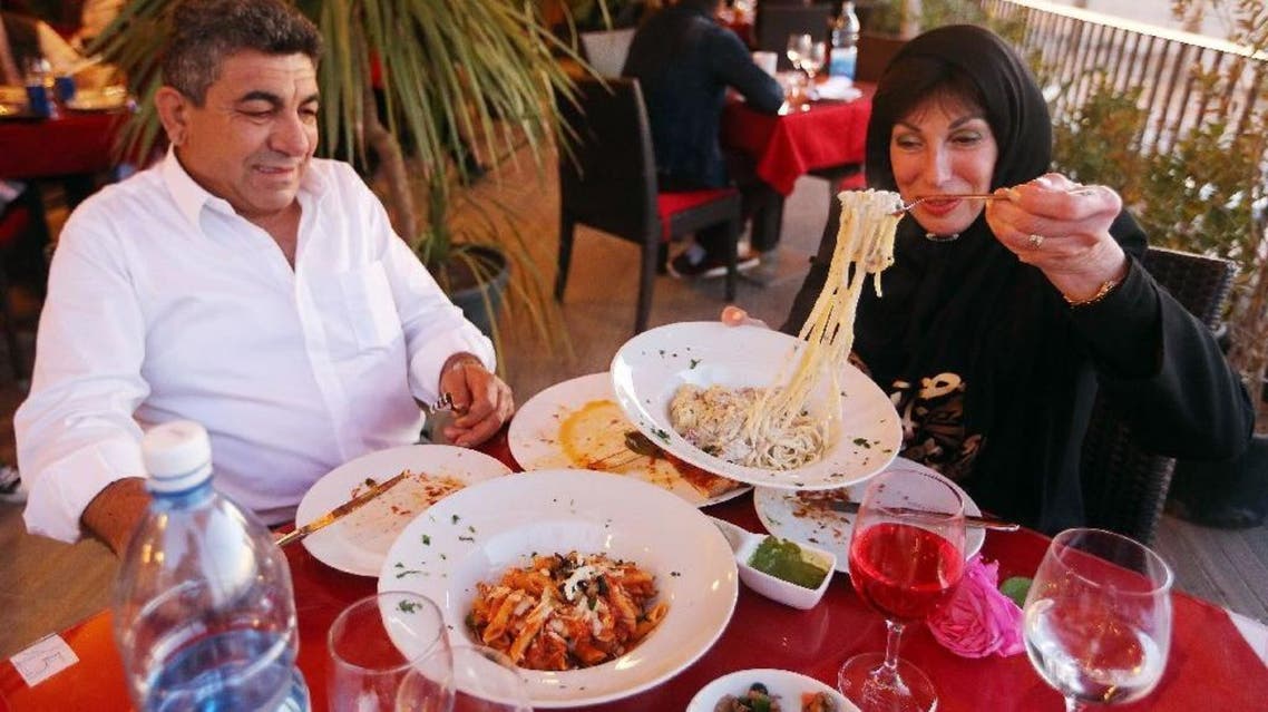 Customers done at Toucan, a Mediterranean "fusion" eatery in once-bustling Tripoli. (AFP)