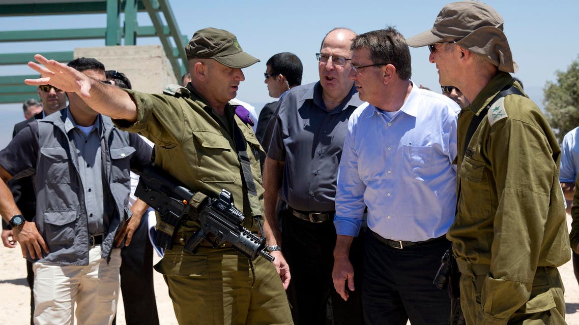 From left, Israel Defense Forces (IDF) 91st Division Commander Moni Katz, directing his right arm forward, Israeli Defense Minister Moshe Ya’alon, US Defense Secretary Ash Carter and Deputy Chief of Staff Maj. Gen. Yair Golan pause as they walk from viewing Hula Valley from the Hussein Lookout, behind them, near Kiryat Shmona, Israel, Monday, July 20, 2015, in northern Israel along the boarder with Lebanon. (AP)