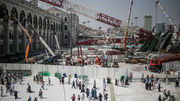 In this Tuesday, Sept. 15, 2015 file photo, Muslim Pilgrims walk past the site of a crane collapse that killed over a hundred Friday at the Grand Mosque in the holy city of Makkah, Saudi Arabia. (AP)