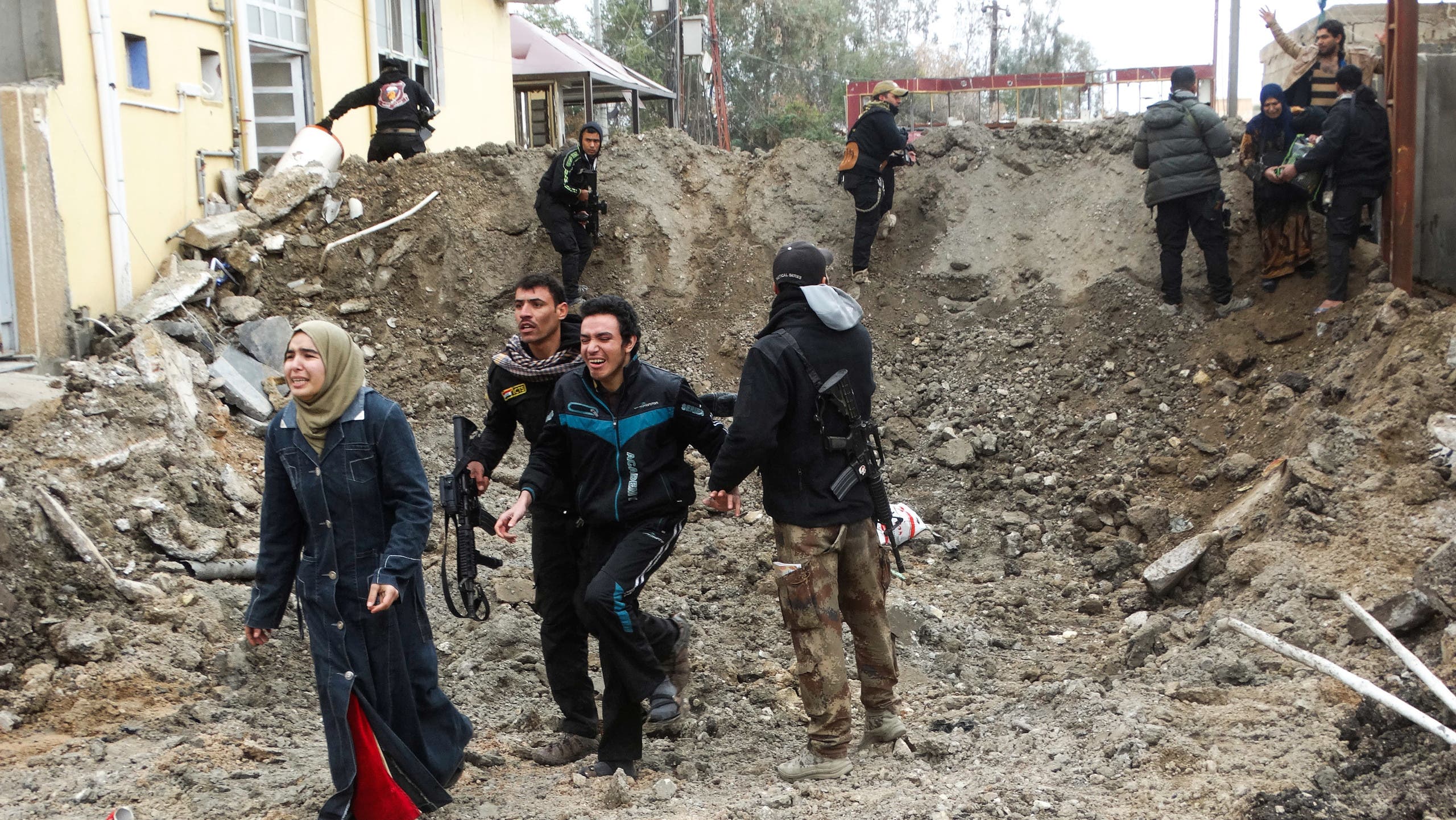 Iraqi security forces and Sunni tribal fighters help trapped civilians cross out of neighborhoods under Islamic State group control in Ramadi in this Jan. 4, 2016, file photo. ap