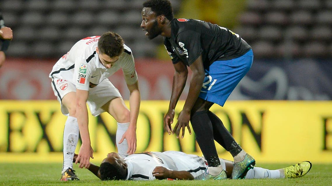 Dinamo's Patrick Ekeng of Cameroon lies on the pitch after collapsing during a league game in Bucharest, Romania, Friday, May 6, 2016. Dinamo Bucharest player Patrick Ekeng died after he collapsed during a match in the Romanian capital on Friday, doctors said. He was 26. (AP Photo) ROMANIA OUT