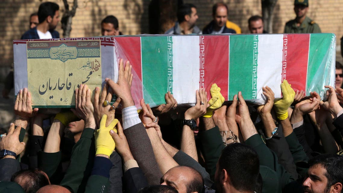 Civilians and armed forces members carry the flag draped coffin of Iranian Revolutionary Guard's Gen. Mohsen Ghajarian, who was killed in fighting in Syria, during his funeral ceremony outside headquarters of the guard's ground forces in Tehran, Iran, Saturday, Feb. 6, 2016. (AP Photo/Vahid Salemi)
