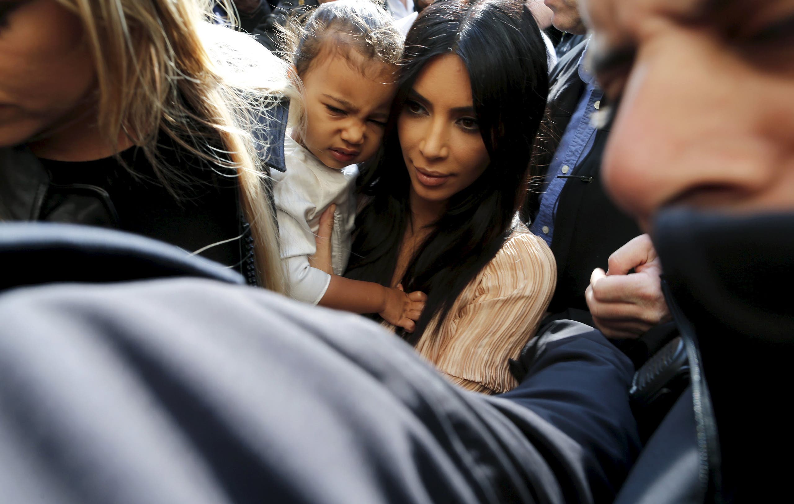 Kim Kardashian holds her toddler daughter North West as they arrive for a baptism ceremony at the Cathedral of Saint James. (Reuters)