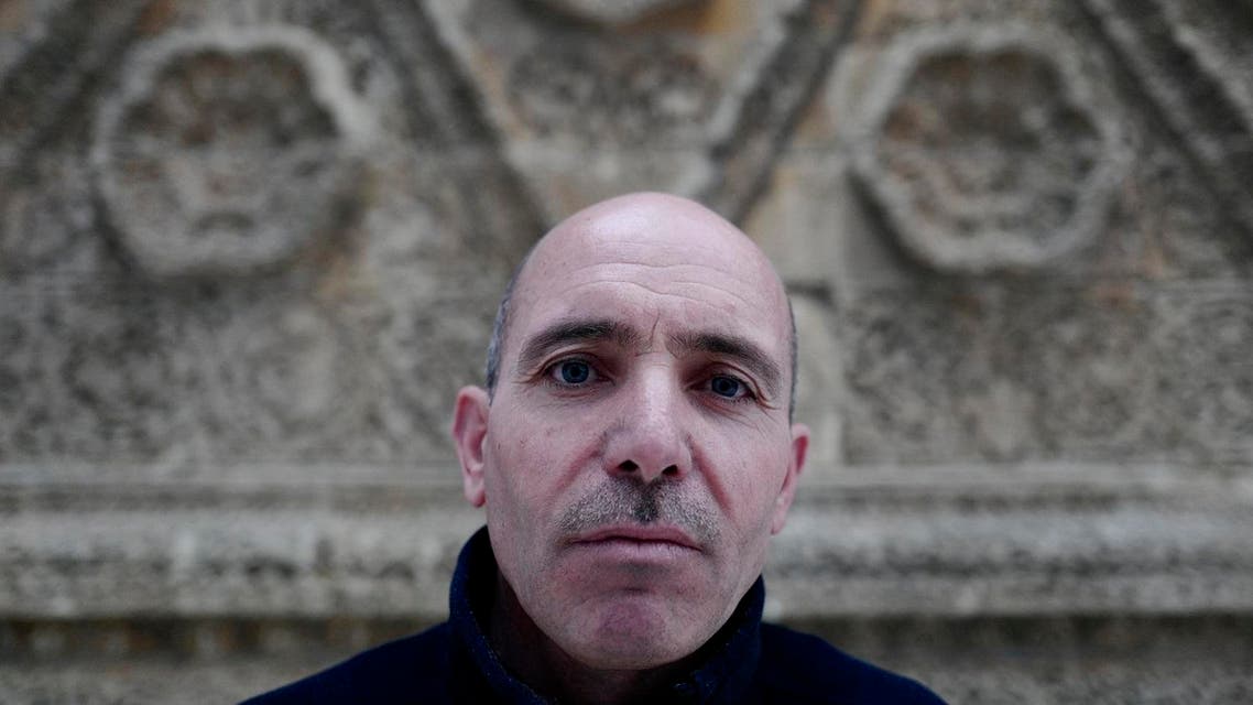 This file photo taken on April 28, 2016 shows Mohamed Al-Subeeh, who used to work in the Mosaics Museum at Maaret Al-Numan in Idlib province, and is now a guide at Berlin's Bode Museum poses for a photo at a ceremony during which funding was made available to continue the Multaka project, at the Museum for Islamic Art in Berlin on April 28, 2016. The Multaka project encourages refugees to act as tour guides for groups of other refugees in selected Berlin museums. John MACDOUGALL / AFP