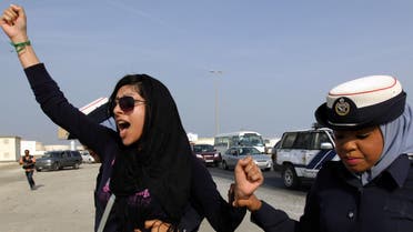 In this Oct. 21, 2012 file photo, Bahraini opposition activist Zainab al-Khawaja, left, gestures while being arrested by police officers in Eker, Bahrain. (AP)