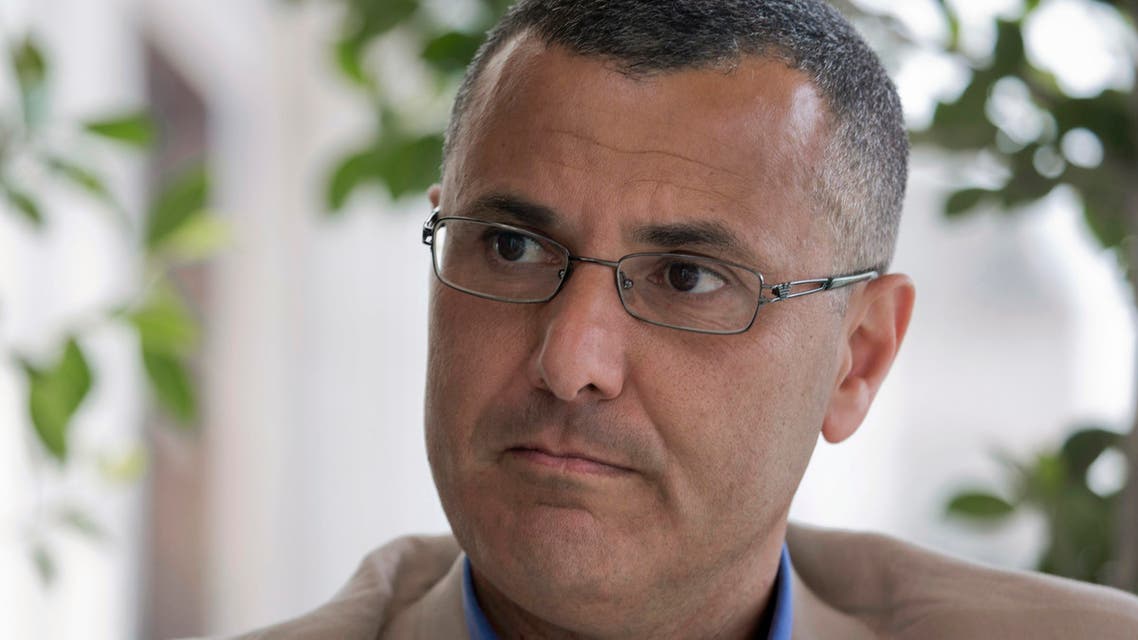 Omar Barghouti listens during an interview with the Associated Press in the West Bank city of Ramallah, Tuesday, May 10, 2016. 