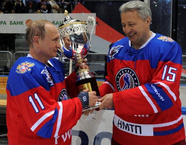 Russian President Vladimir Putin and Soviet former player Alexander Yakushev hold a trophy as they take part in a gala game of the Night Ice Hockey League in Sochi, Russia, May 10, 2016. Mikhail Klimentyev/Sputnik/Kremlin via Reuters