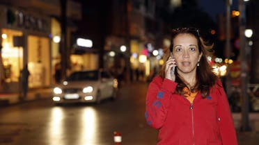 Dutch-Turkish journalist Ebru Umar talks on her mobile phone in Kusadasi, Turkey, Monday, April 25, 2016. AP