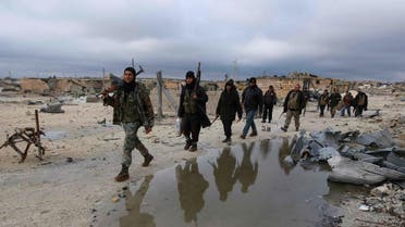 Rebel fighters walk on the al-Breij frontline, after what they said was an advance by them in the Manasher al-Hajr area where the forces of Syria's President Bashar al-Assad were stationed, in Aleppo January 7, 2015. REUTERS