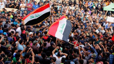  Protesters hold national flags as they chant anti-government slogans during a demonstration against the security forces' failure to protect them from car bombs at the site of yesterday's car bomb attack in the Iraqi capital's eastern district of Sadr City, Iraq, Thursday, May 12, 2016. (AP Photo/Karim Kadim)