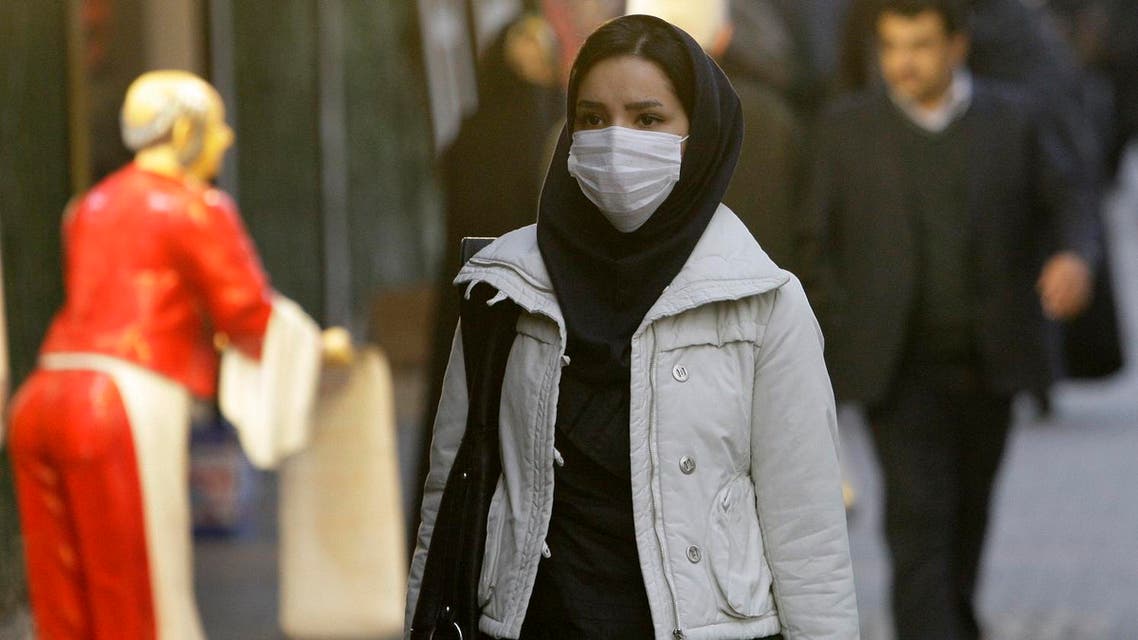 An Iranian woman wears a mask to help guard against dangerous levels of air pollution as she walks in the center of the smog-filled capital, Tehran, Iran. (File photo: AP)