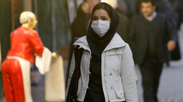 An Iranian woman wears a mask to help guard against dangerous levels of air pollution as she walks in the center of the smog-filled capital, Tehran, Iran. (File photo: AP)