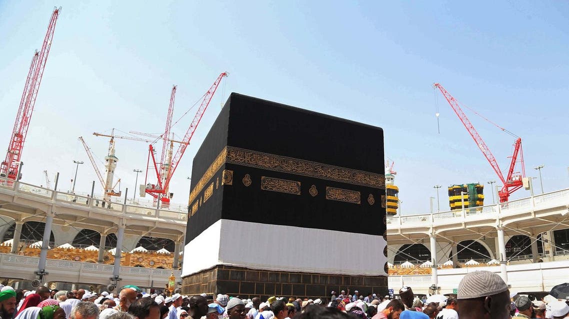 In this Saturday, Sept. 12, 2015 file photo, Muslim pilgrims walk around the Kaaba, the cubic building at the Grand Mosque in the Muslim holy city of Mecca, Saudi Arabia. Employees at giant construction firm, the Saudi Binladin Group, have set fire to more than seven company buses to protest a reportedly large round of looming layoffs and not being paid their salaries for months. (AP)