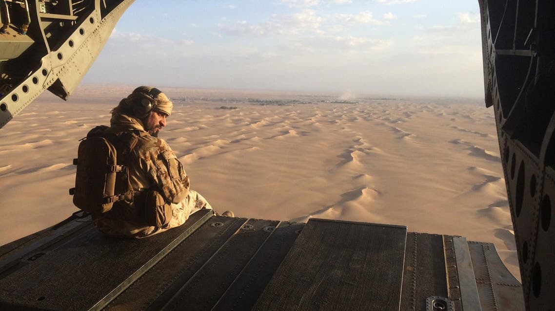 In this Sept. 17, 2015 photo, an Emirati gunner watches for enemy fire from the rear gate of a United Arab Emirates Chinook military helicopter flying over Yemen. The United Arab Emirates is taking part in regional conflicts and likely has spent into the billions of dollars to support its military in 2015 as well, a new report revealed. Both the UAE and Saudi Arabia also sent troops into Bahrain to put down its 2011 Arab Spring-inspired protests. (AP Photo/Adam Schreck, File)