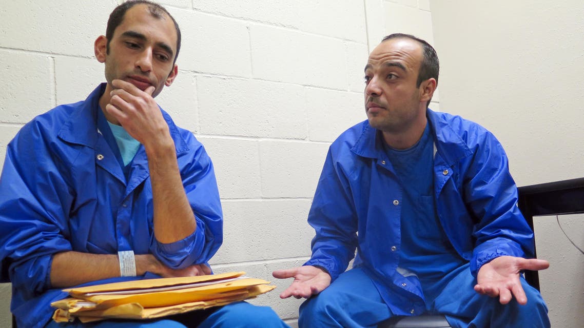 In this Thursday, Dec. 10, 2015 photo, Mounis Hammouda, left, and Hisham Shaban sit in a small room at an immigration detention center in Eloy, Ariz.