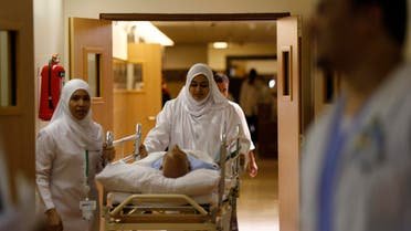 Nurses wheel a patient in the emergency department at Al-Noor Specialist Hospital in Mecca September 30, 2014. According to hospital director Dr. Mohammad bin Omar, the hospital did not record any cases of pilgrims bearing the MERS coronavirus or Ebola virus entering Mecca for the Haj season, and that most of the cases referred to the hospital were of elderly patients with common ailments. REUTERS