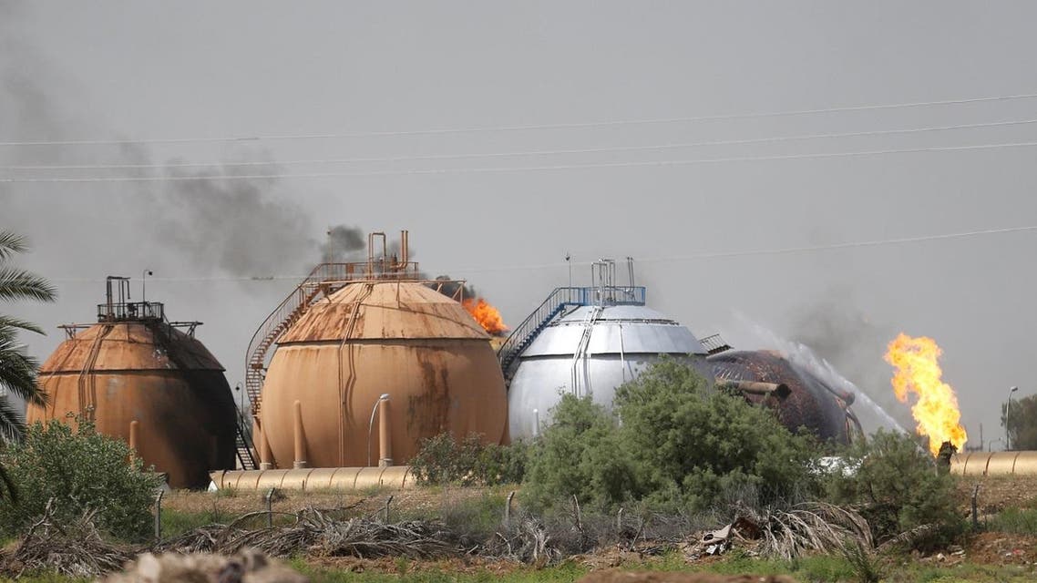 Smoke rises from gas storage tanks after a bomb attack against a state-run cooking gas factory in Taji at Baghdad's northern outskirts, Iraq May 15, 2016. REUTERS