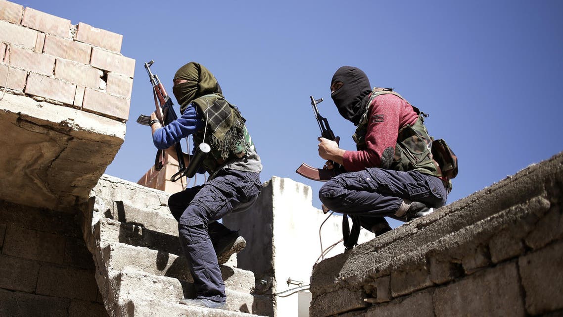 Militants from the Kurdistan Workers' Party, or PKK, run as they attack Turkish security forces in Nusaydin, Turkey, Tuesday, March 1, 2016.
