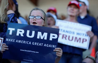 Supporters hold signs as Republican U.S. presidential candidate Donald Trump speaks during a campaign rally in Lynden, Washington, U.S., May 7, 2016. REUTERS