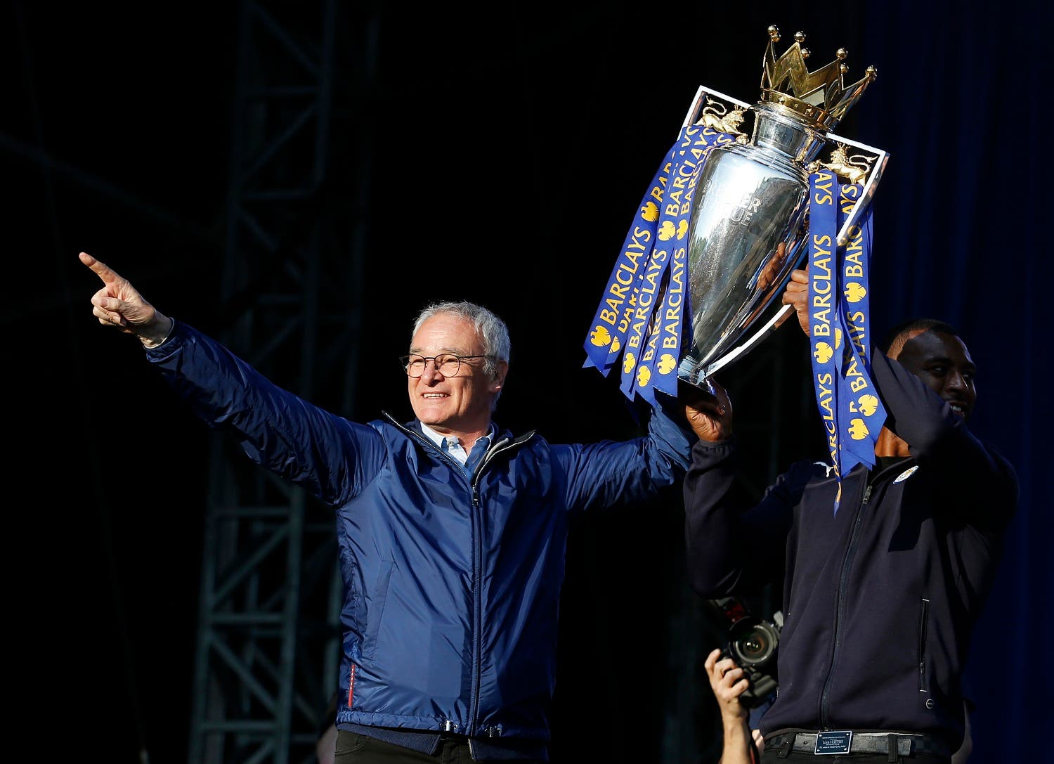 Leicester City manager Claudio Ranieri and Wes Morgan on the stage with the trophy during the parade. (Action Images via Reuters)