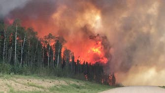 Flare-ups, thick smoke from Canadian wildfires delay residents' return