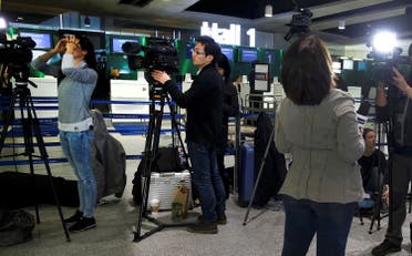 TV crews report near the EgyptAir desk at Charles de Gaulle airport in Paris. (Reuters)