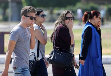 Unidentified relatives and friends of passengers who were flying in an EgyptAir plane wait outside the Egyptair in-flight service building in Cairo. (Reuters)