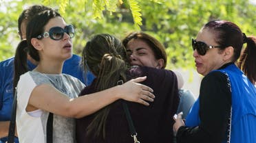 Families of passengers who were flying on board an EgyptAir plane that vanished from radar en route from Paris to Cairo react as they wait outside a services hall at Cairo international airport on May 19, 2016. (AFP)