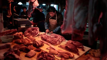  A man cuts meat at his shop in Shanghai, China, Thursday, Feb. 10, 2011. (AP Photo/Eugene Hoshiko)