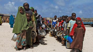 Holding their pots Somali children from southern Somalia, lineup to receive cooked food in Mogadishu, Somalia, Monday, Aug. 15, 2011. AP