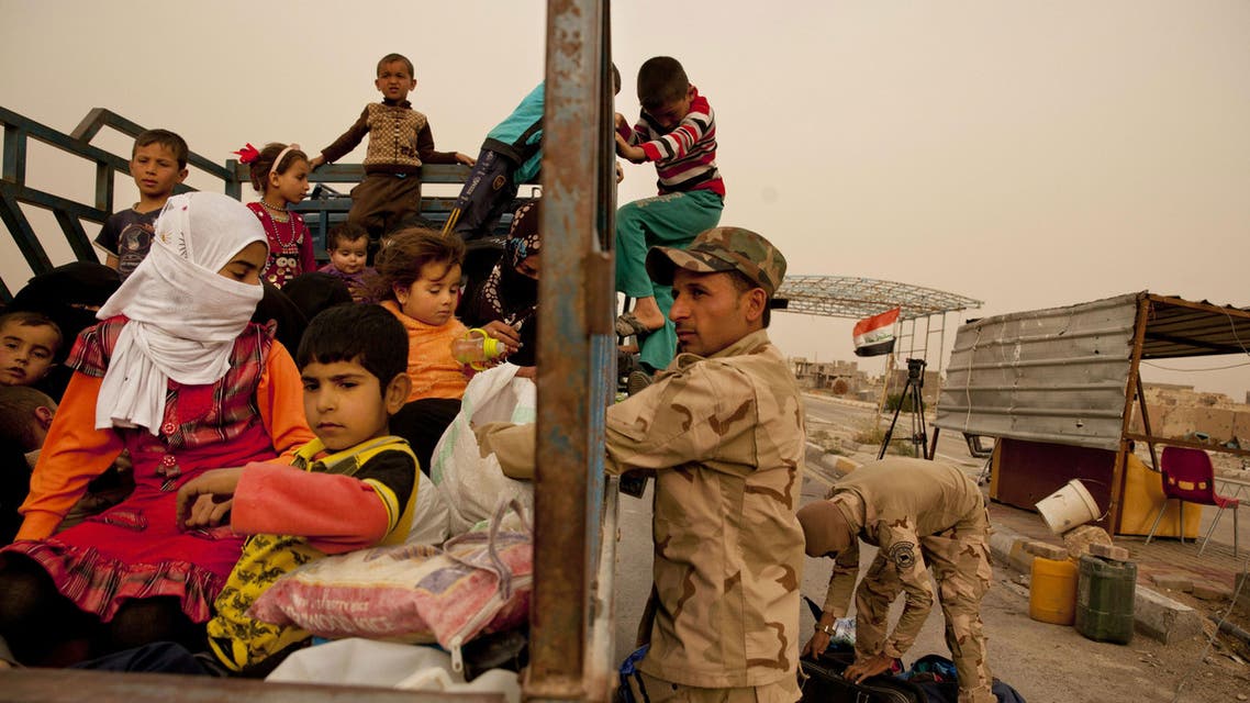 In this Sunday, March 20, 2016 photo, Iraq soldiers search a convoy of families fleeing ISIS-held Hit, Iraq, at a checkpoint on the western edge of Ramadi, Iraq. (Reuters)