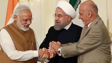 In this photo released by official website of the office of the Iranian Presidency, Afghan President Ashraf Ghani, right, Iranian President Hassan Rouhani, center, and Indian Prime Minister Narendra Modi, hold hands in a show of solidarity at the Saadabad Palace in Tehran, Iran, Monday, May 23, 2016. (AP)