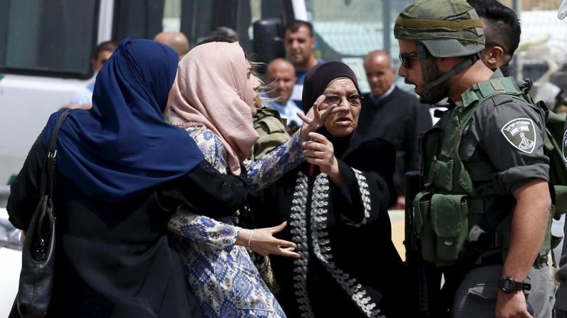 A Palestinian woman argues with an Israeli border policeman near the scene where two Palestinians who the Israeli military said tried to stab security forces were shot dead by Israeli police near Qalandia checkpoint near the West Bank city of Ramallah April 27 REUTERS