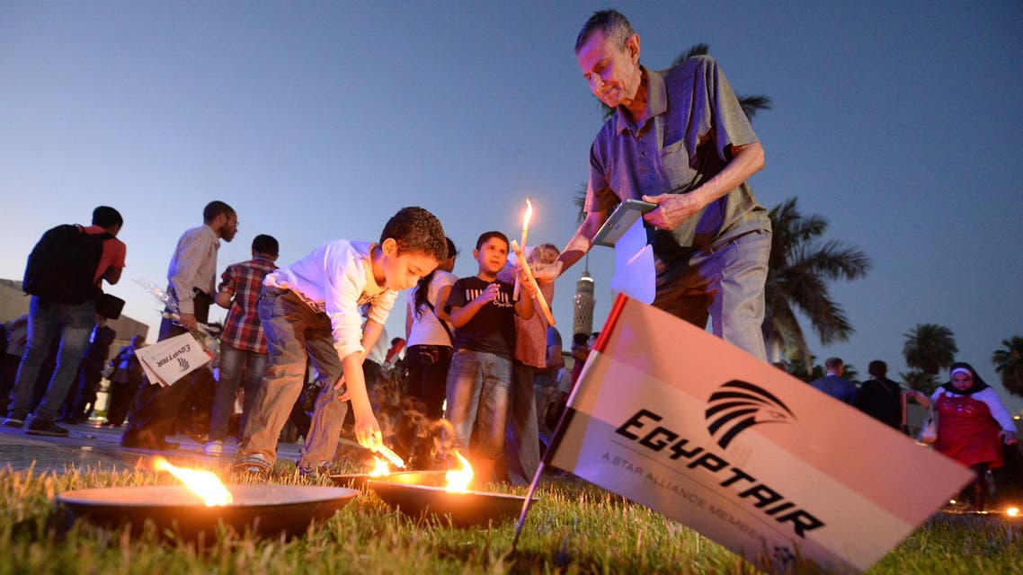 Egyptians light candles during a candlelight vigil for the 66 victims of the EgyptAir MS804 flight that crashed in the Mediterranean Sea, at the Cairo Opera House in the Egyptian capital on May 26, 2016.