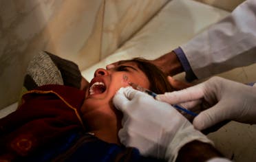 An Afghan girl, affected by Cutaneous leishmaniasis, withers with pain as she is injected by a doctor at a free specialized clinic for Leishmaniasis supported by World Health Organization. (File photo: AP)
