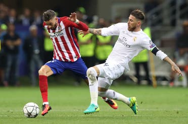 Real Madrid's Sergio Ramos fouls Atletico Madrid's Yannick Ferreira Carrasco resulting in a yellow card to Ramos reuters